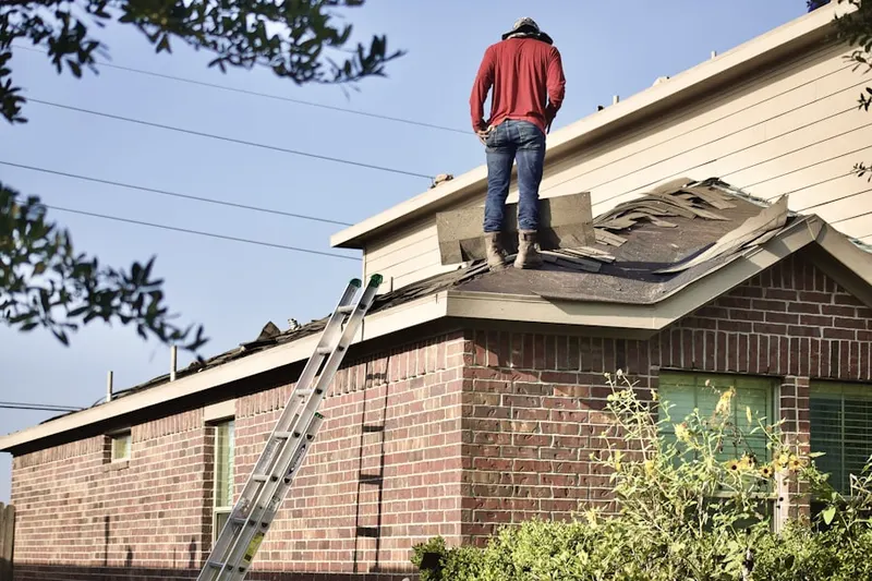 Professional roofer working on a residential roof in Fallsington
